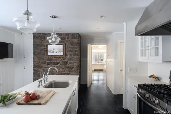 a bathroom with a sink a large mirror and shower