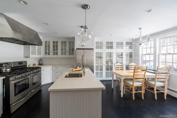 a kitchen with a stove a table and chairs