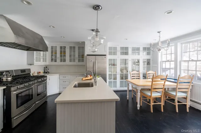 a kitchen with a stove a table and chairs