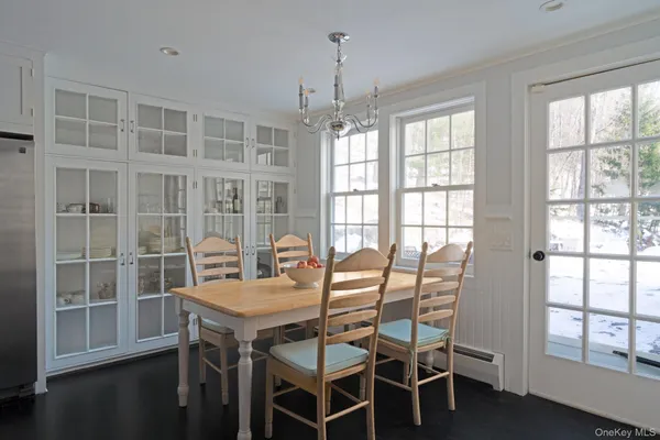 a view of a dining room with furniture window and wooden floor