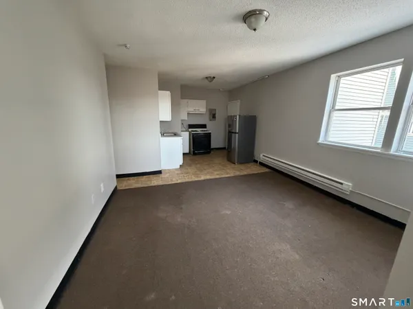 an empty room with a empty space and windows