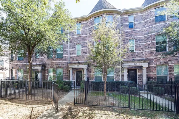 a view of a brick building next to a yard