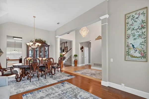 a view of a dining room with furniture and a chandelier