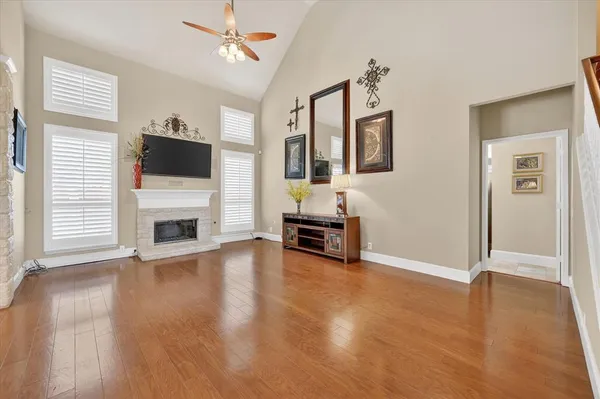 a view of a livingroom with furniture a flat screen tv and staircase