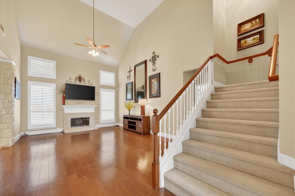 1371 San Rafael Drive Rockwall, TX 75087 - Photo 14 of 35 a view of a livingroom with furniture a flat screen tv and staircase