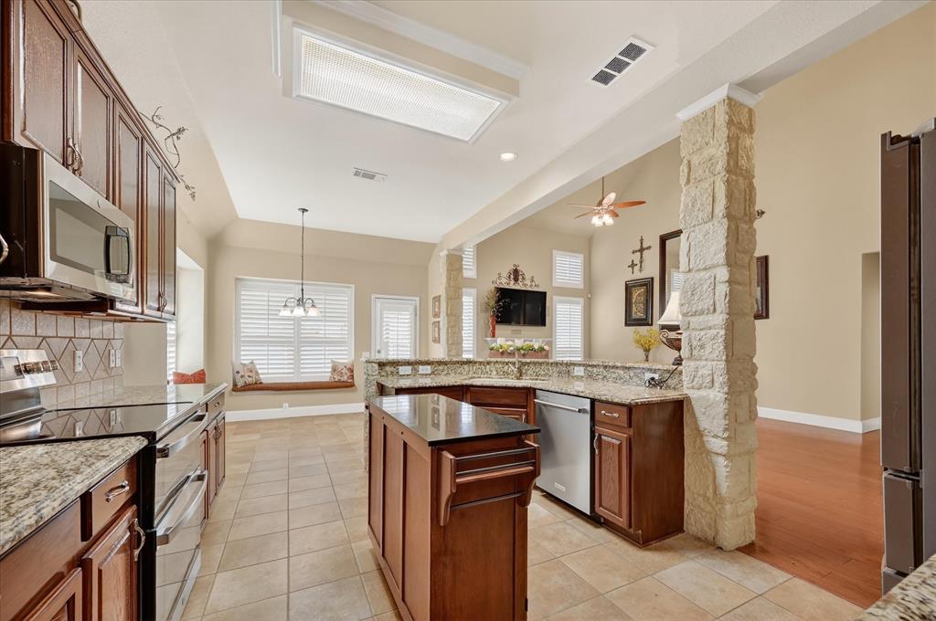 1371 San Rafael Drive Rockwall, TX 75087 - Photo 18 of 35 a large kitchen with a large counter top appliances and cabinets
