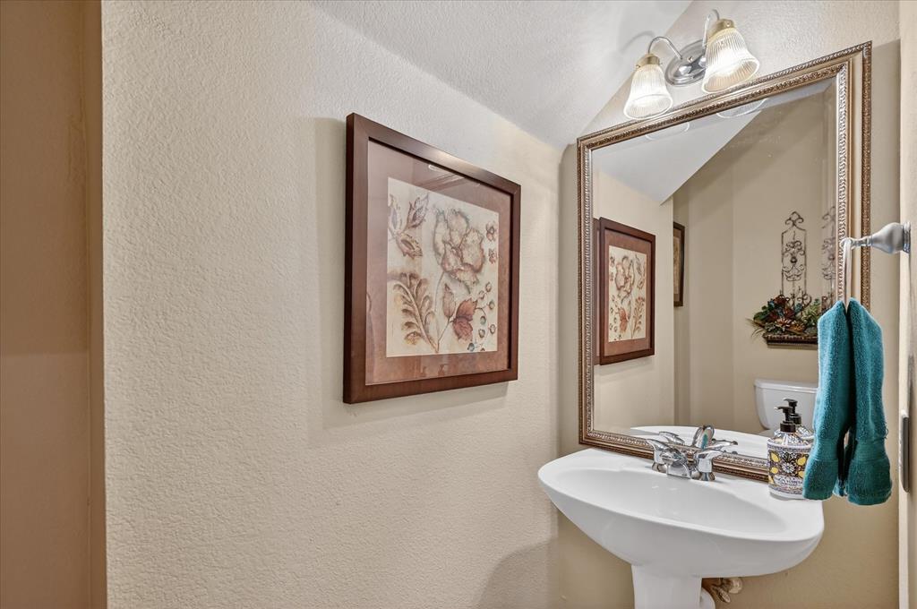 1371 San Rafael Drive Rockwall, TX 75087 - Photo 21 of 35 a bathroom with a sink and a mirror