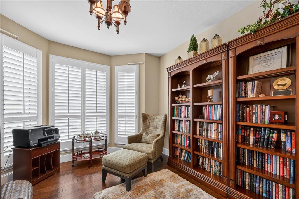 1371 San Rafael Drive Rockwall, TX 75087 - Photo 24 of 35 a living room with fireplace furniture and a book shelf