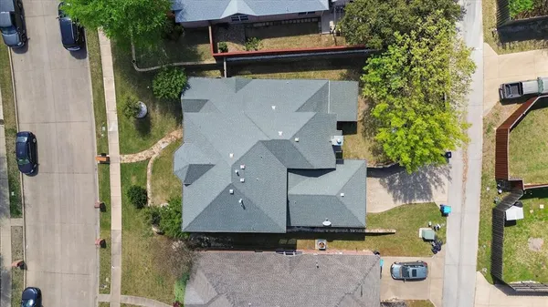 an aerial view of residential houses with outdoor space and parking