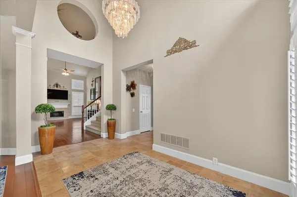 a view of a dining room with furniture and chandelier