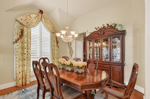 a view of a dining room with furniture and chandelier