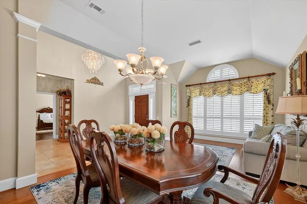a view of a dining room with furniture and chandelier