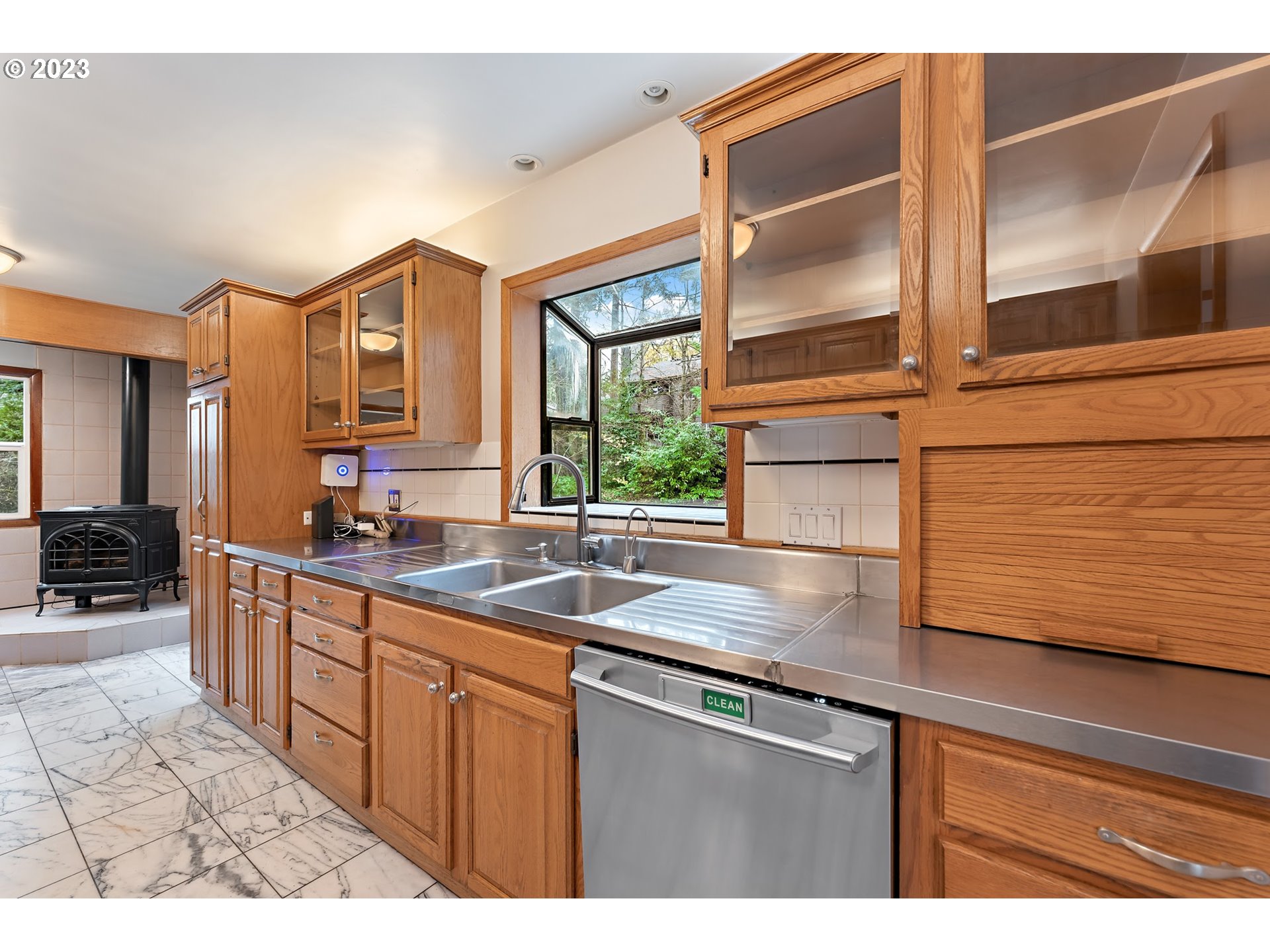 2435 Southwest Dakota Street Portland, OR 97239 - Photo 21 of 47 a kitchen with stainless steel appliances granite countertop a sink and a cabinets