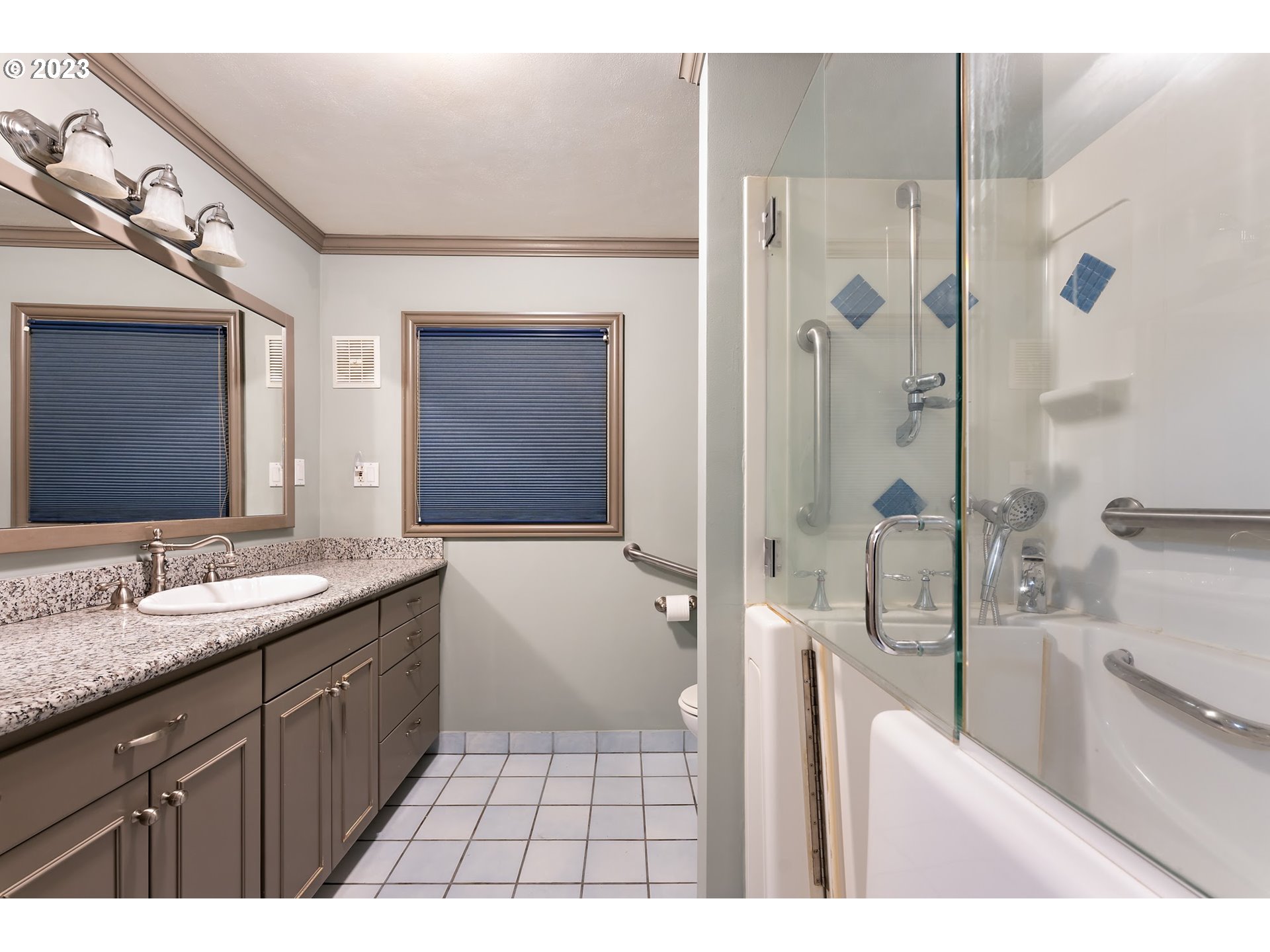 2435 Southwest Dakota Street Portland, OR 97239 - Photo 29 of 47 a spacious bathroom with a granite countertop sink mirror and shower