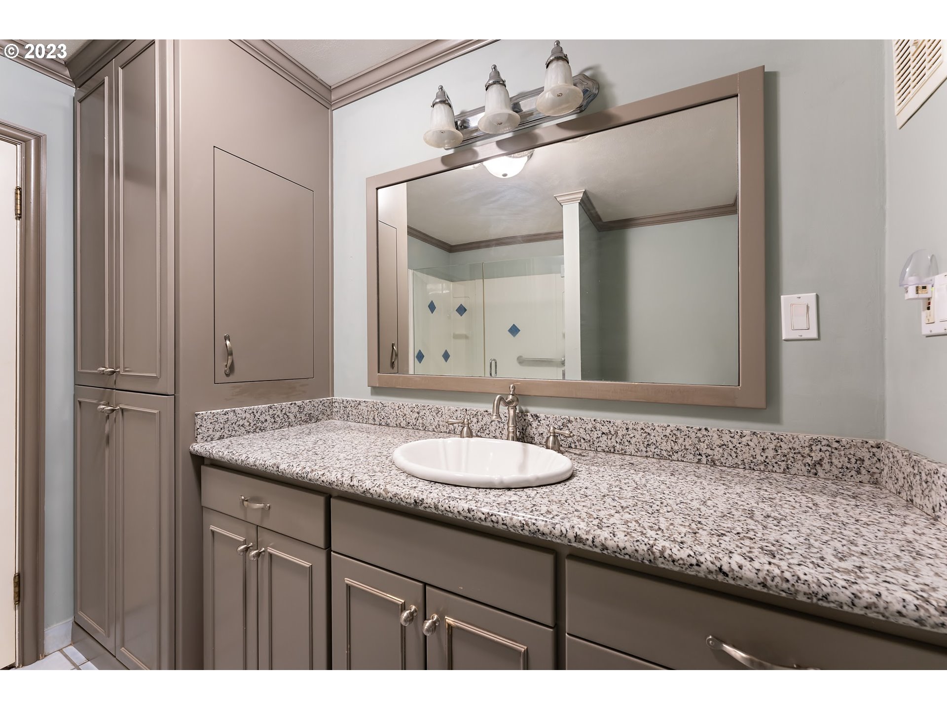 2435 Southwest Dakota Street Portland, OR 97239 - Photo 30 of 47 a bathroom with a granite countertop sink and a mirror