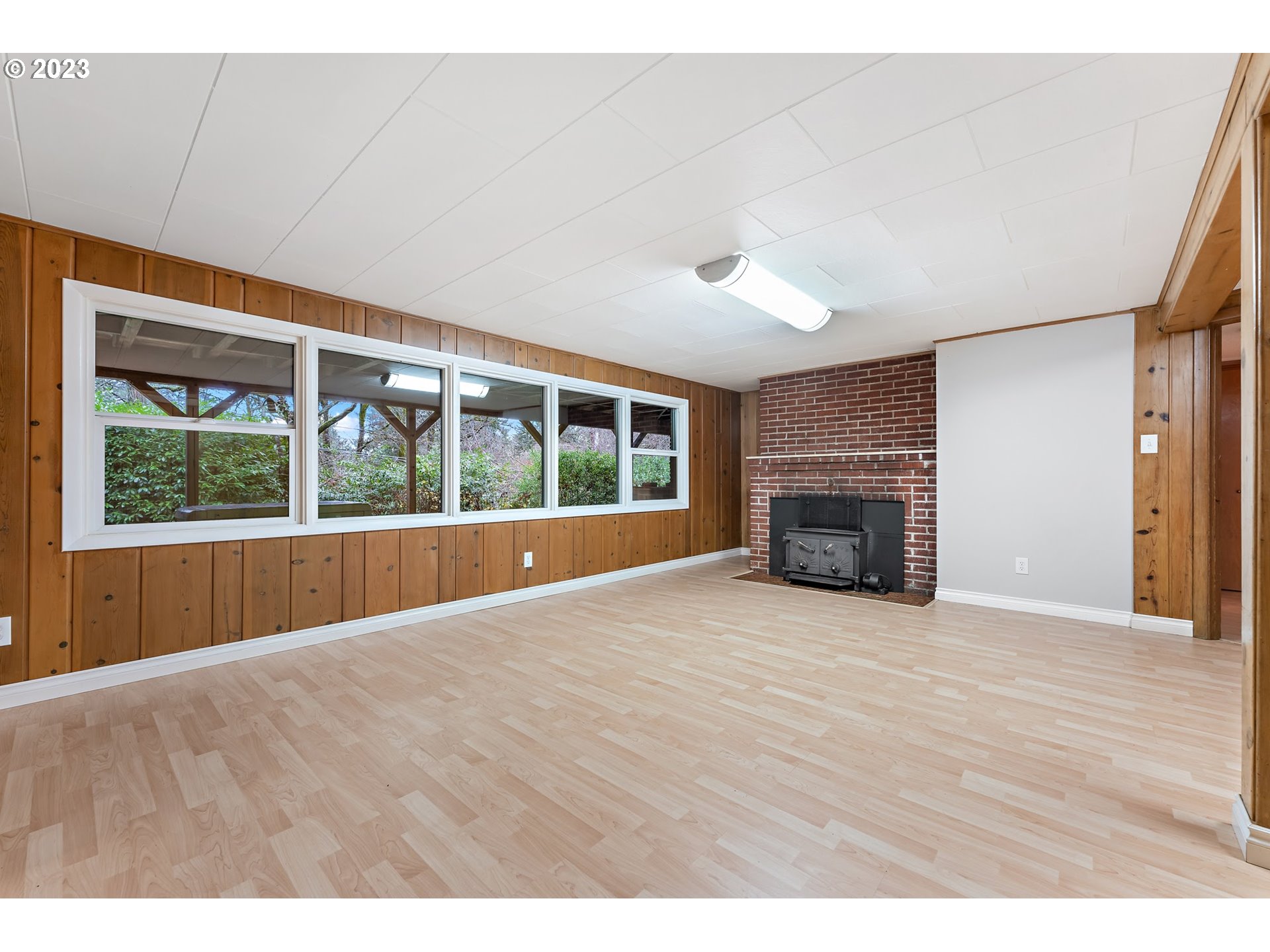 2435 Southwest Dakota Street Portland, OR 97239 - Photo 34 of 47 a view of an empty room with wooden floor and a window