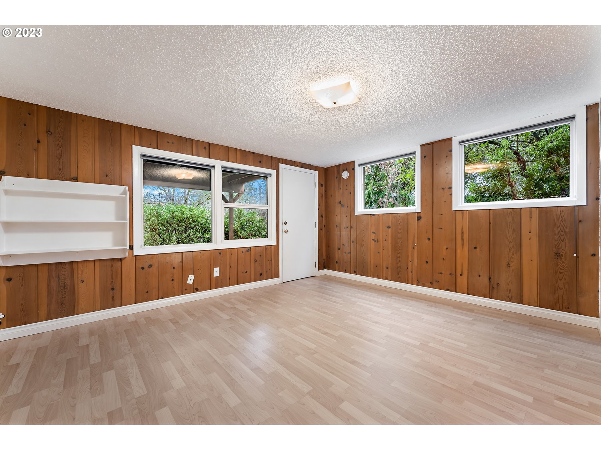 2435 Southwest Dakota Street Portland, OR 97239 - Photo 35 of 47 a view of an empty room with wooden floor and a window