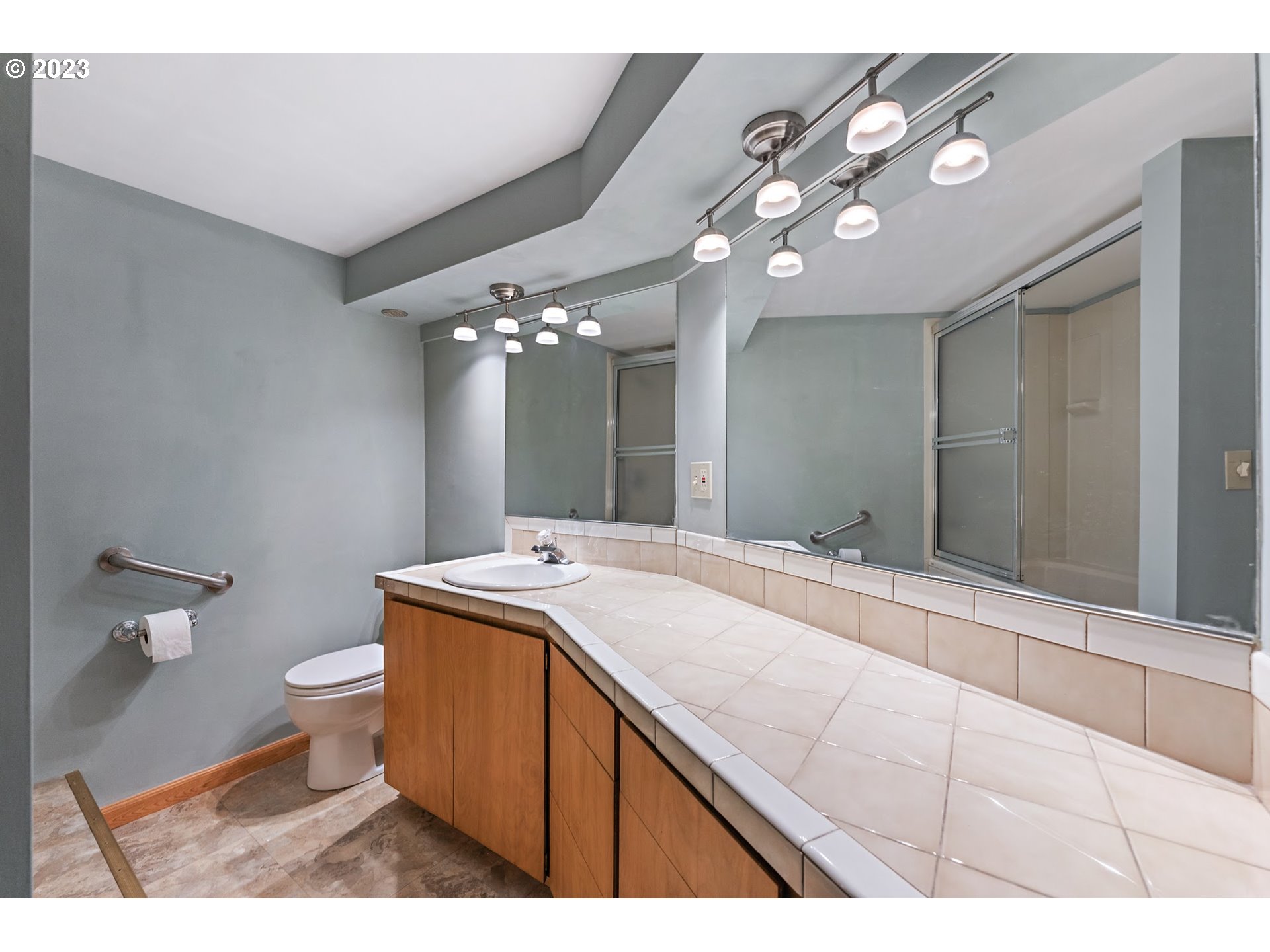 2435 Southwest Dakota Street Portland, OR 97239 - Photo 36 of 47 a bathroom with a sink vanity and a mirror
