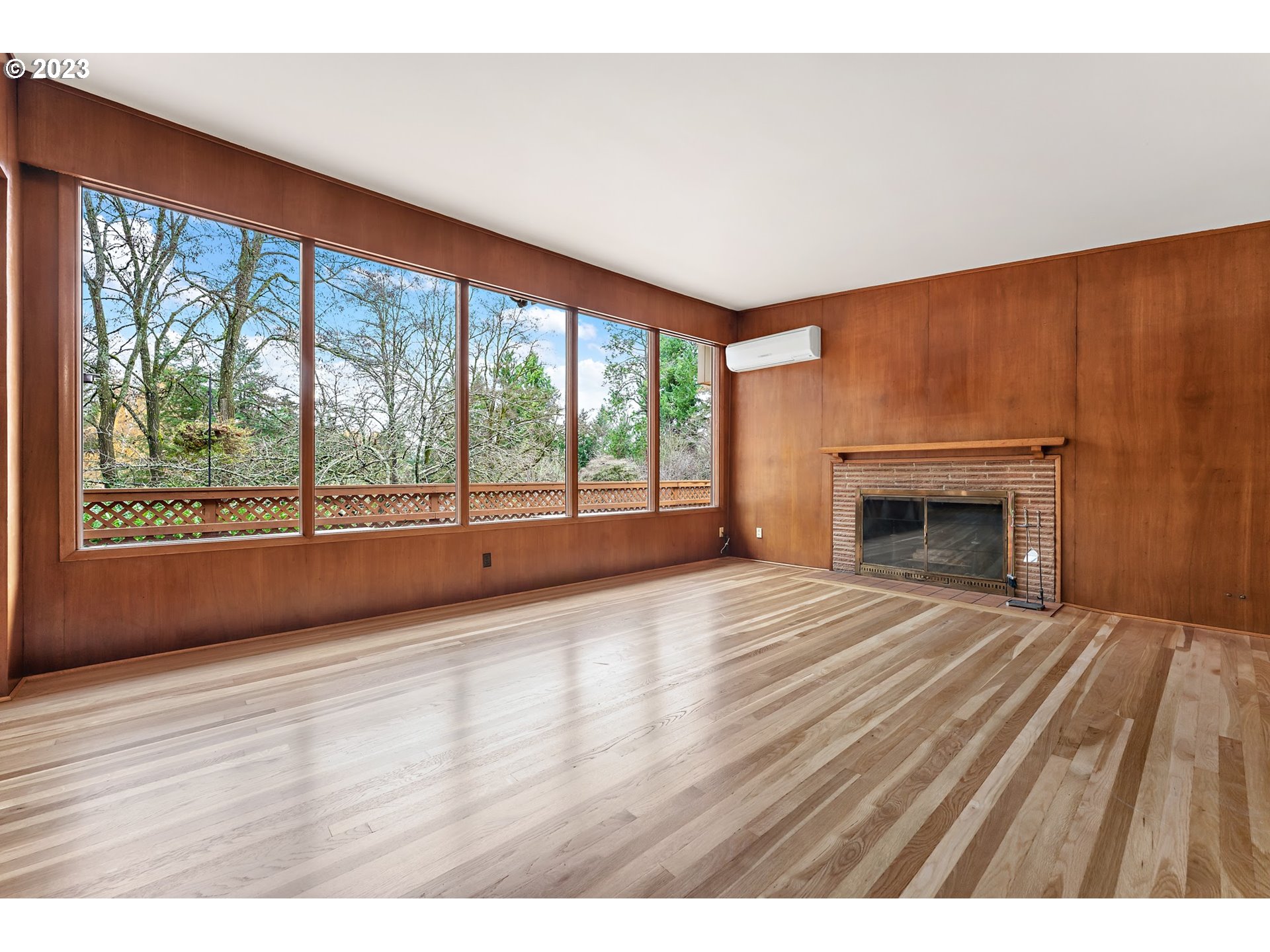 2435 Southwest Dakota Street Portland, OR 97239 - Photo 10 of 47 a view of an empty room with wooden floor and a window