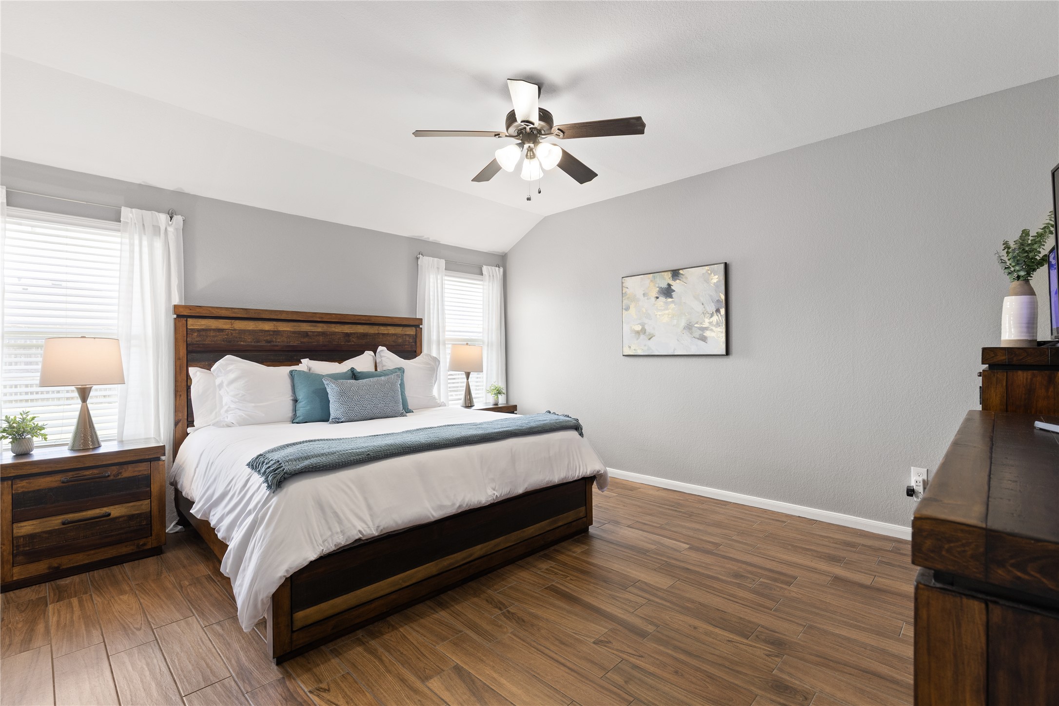 256 Alpha Kyle, TX 78640 - Photo 14 of 27 Natural light illuminates this spacious bedroom, featuring warm wood-look tile flooring.