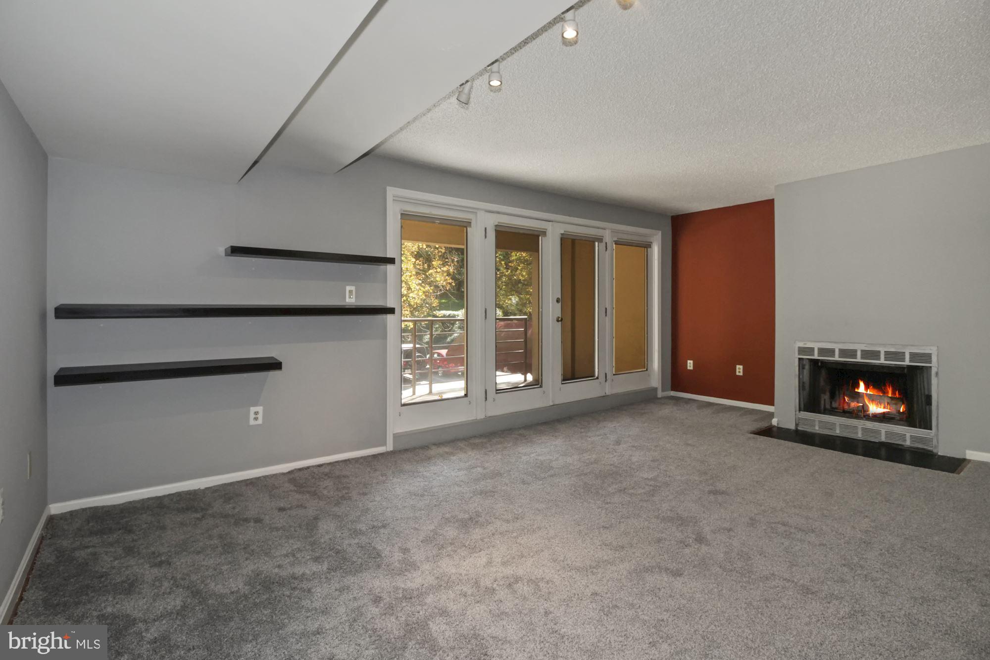 1040 Deer Ridge Drive, Unit 309 Baltimore, MD 21210 - Photo 8 of 31 Living room with french doors to balcony