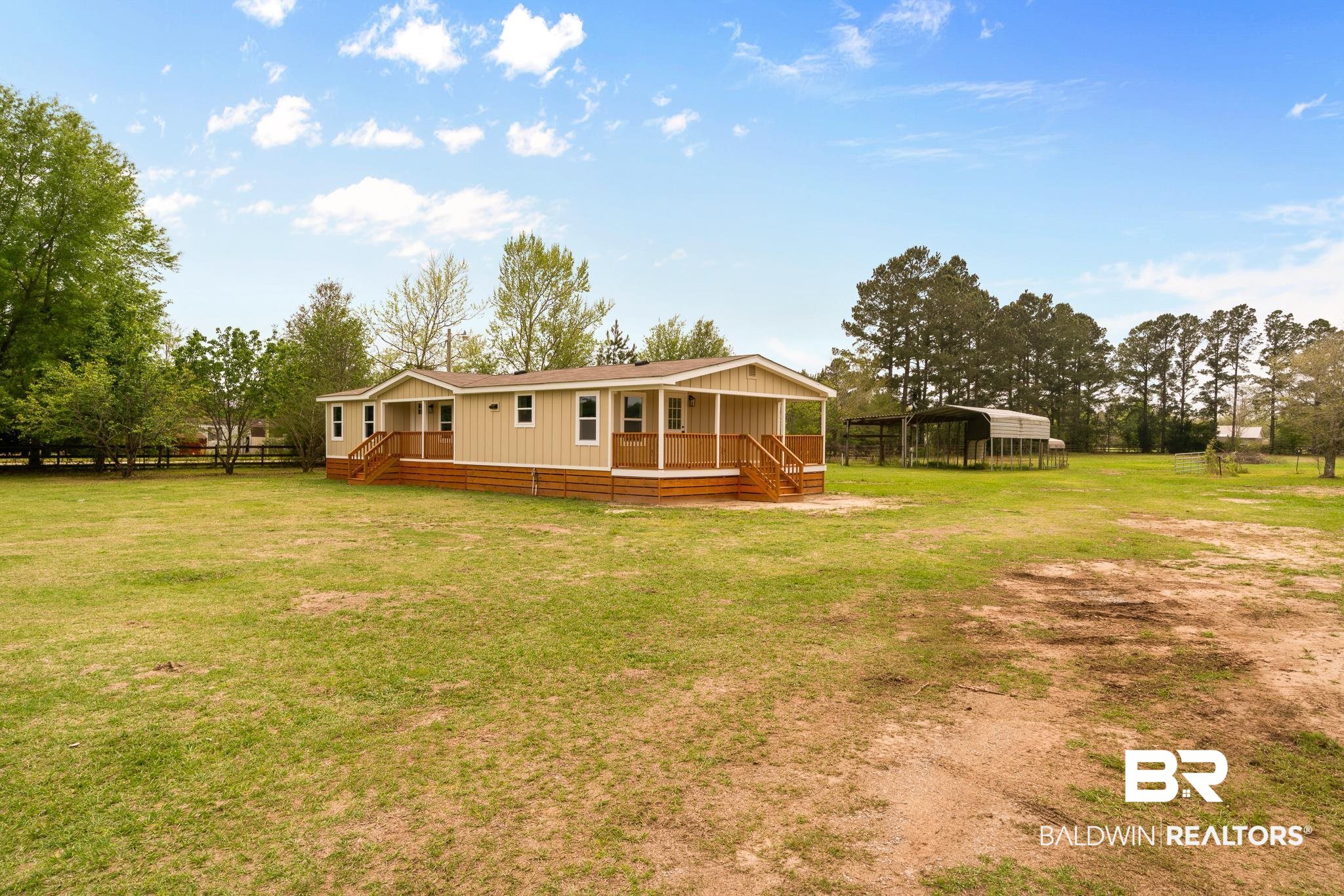 12645 Breman Road Elberta, AL 36530 - Photo 2 of 44 Back of house with crawl space, a carport, a yard, and a wooden deck