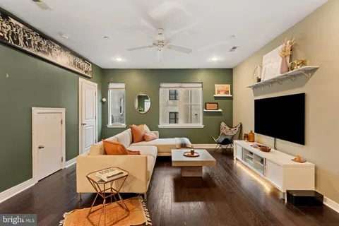 a bedroom with furniture and a flat screen tv