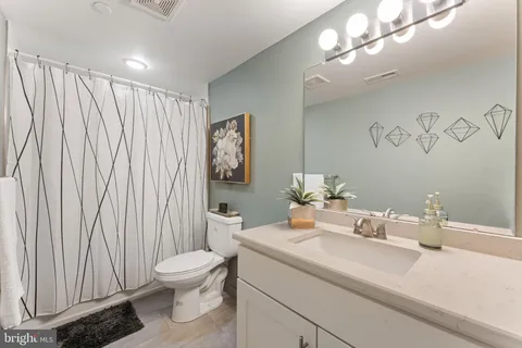 a bathroom with a toilet a sink and a mirror