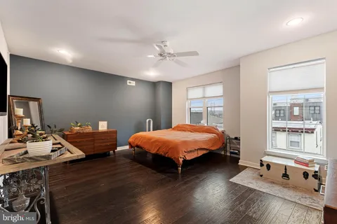 a bedroom with furniture and wooden floor