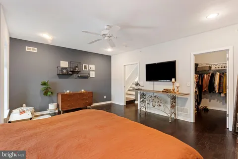 a bedroom with furniture and a flat screen tv