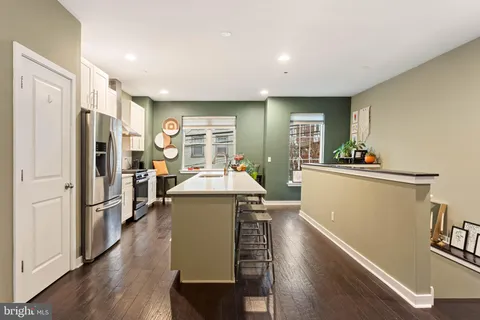 a kitchen with stainless steel appliances a refrigerator and a stove top oven