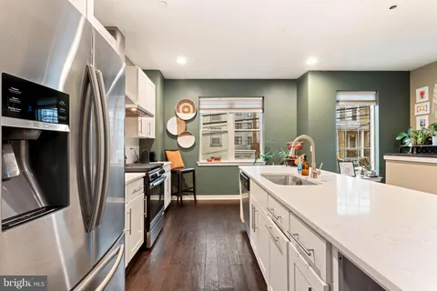 a kitchen with a sink stove and refrigerator