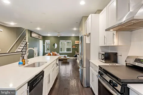 a kitchen with a sink appliances and a counter top space