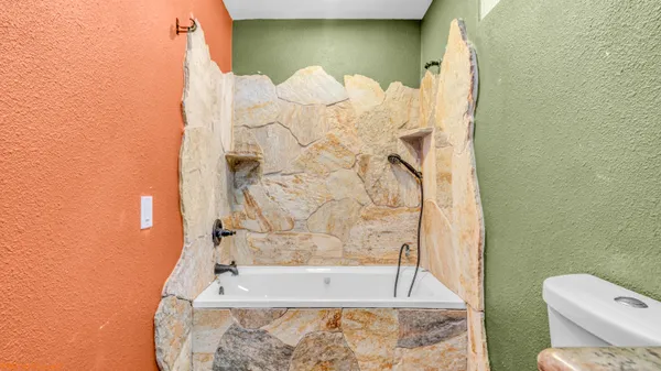 a bathroom with a bathtub and shower