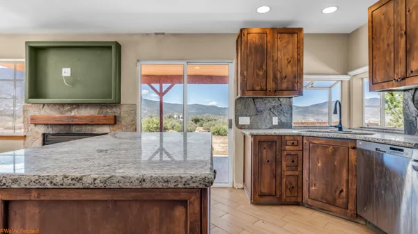 a kitchen with granite countertop wooden cabinets and a granite counter tops