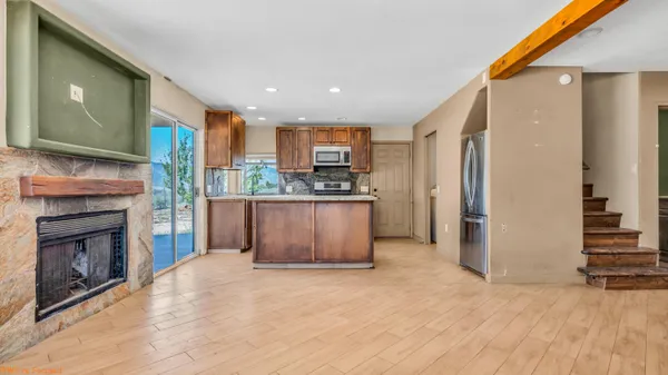a kitchen with stainless steel appliances granite countertop a refrigerator and a stove top oven