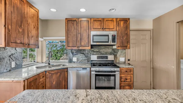 a kitchen with a stove a sink and a microwave