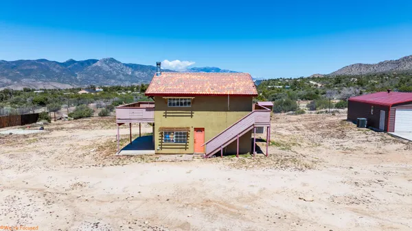 a view of a house with a yard and sitting area
