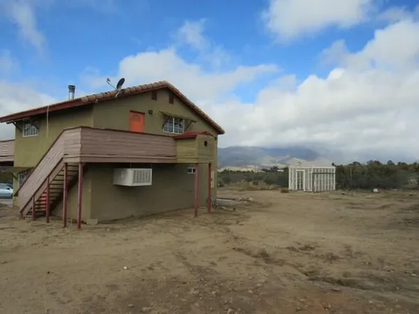 a house with trees in the background
