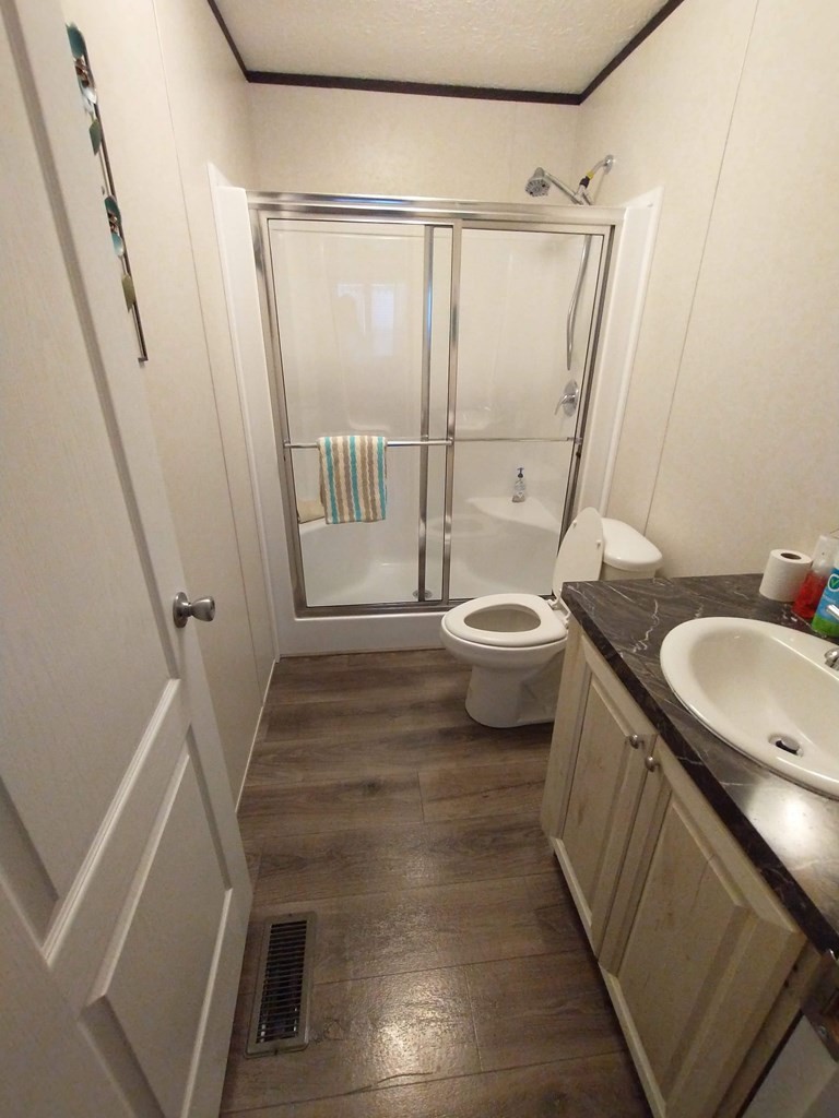 2438 Ridge Road Pigeon Forge, TN 37863 - Photo 25 of 37 a bathroom with a sink a toilet a mirror and shower
