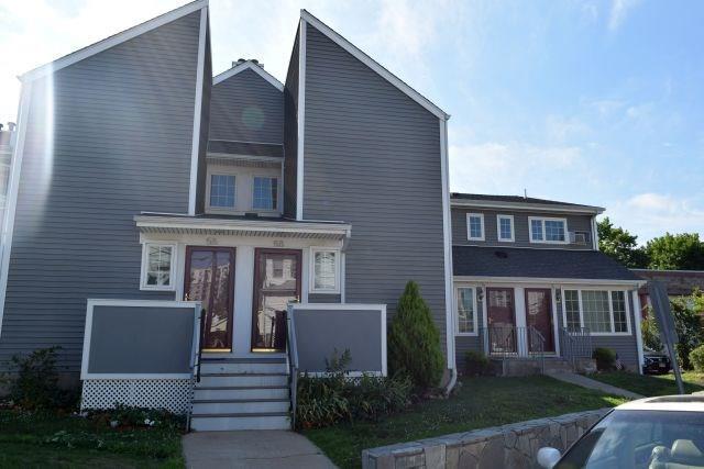 58 Elmcroft Road, Unit 58 Stamford, CT 06902 - Photo 1 of 1 a view of a house with a yard and plants