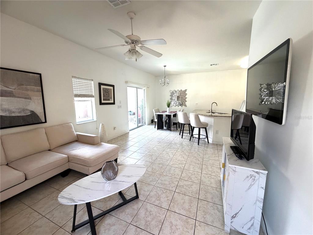 4573 Ada Lane Kissimmee, FL 34746 - Photo 4 of 37 a living room with furniture and a flat screen tv