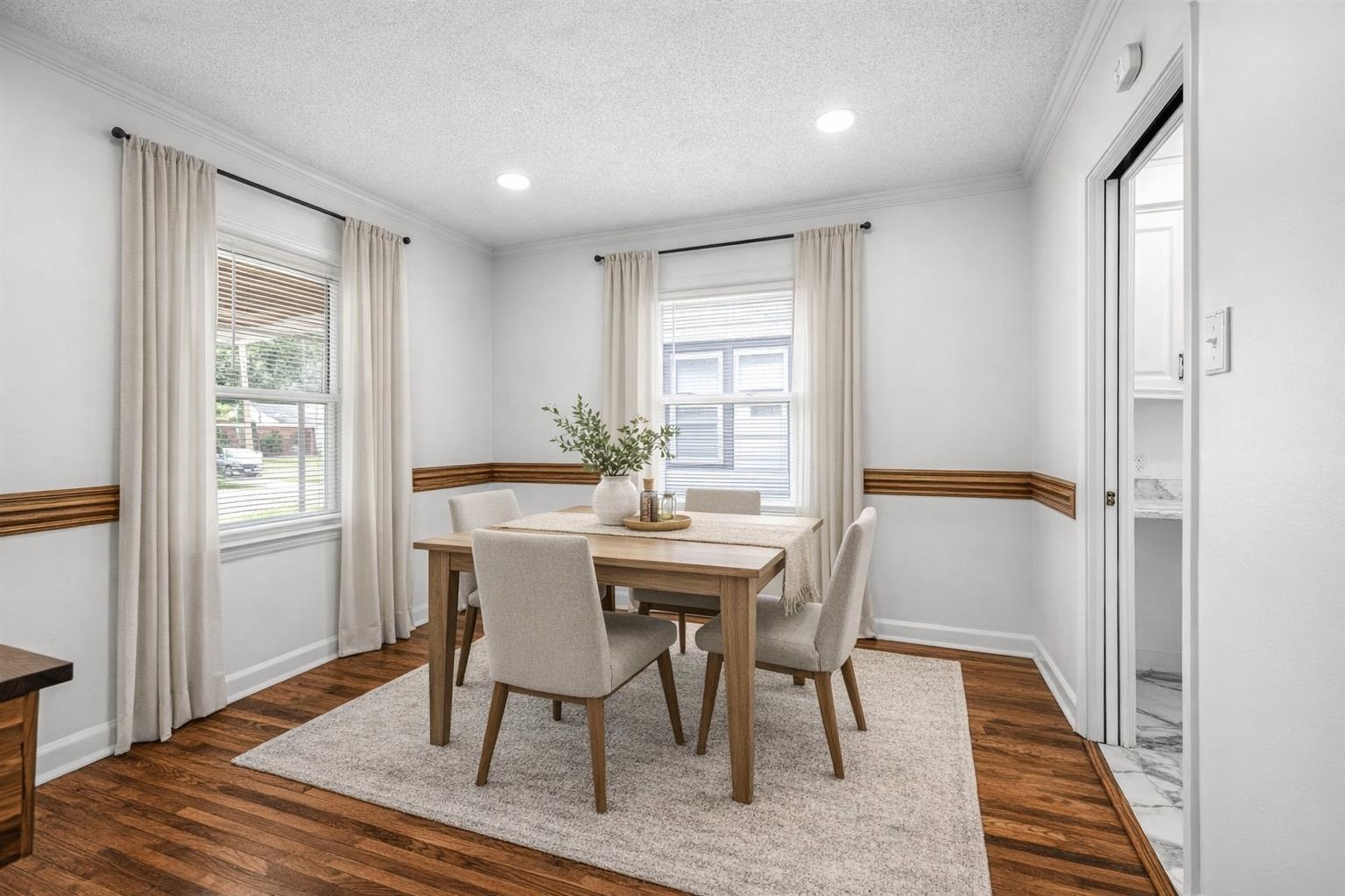 1244 Wells Station Road Memphis, TN 38122 - Photo 19 of 36 Dining space featuring dark wood-type flooring, ornamental molding, healthy amount of natural light, a textured ceiling, and recessed lighting