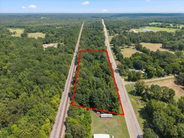 a view of a green field with an outdoor space