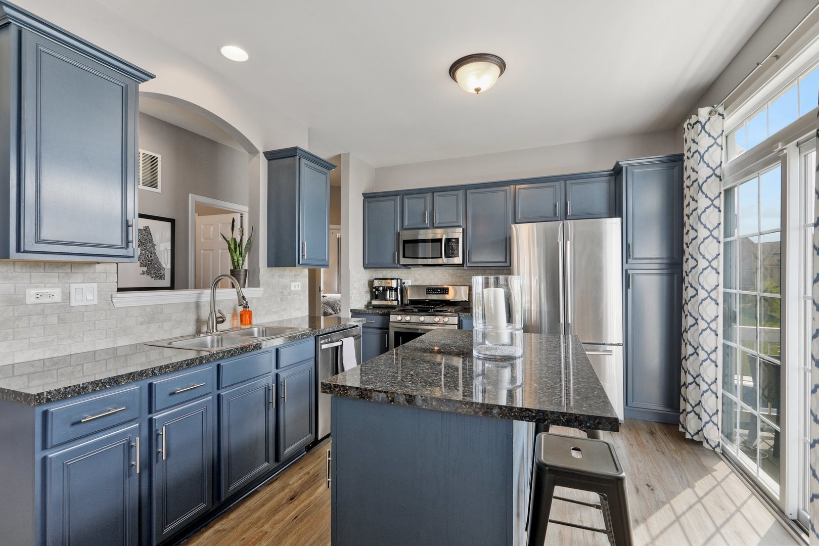 301 Timber Ridge Court Joliet, IL 60431 - Photo 5 of 17 a kitchen with stainless steel appliances granite countertop a refrigerator stove microwave and sink