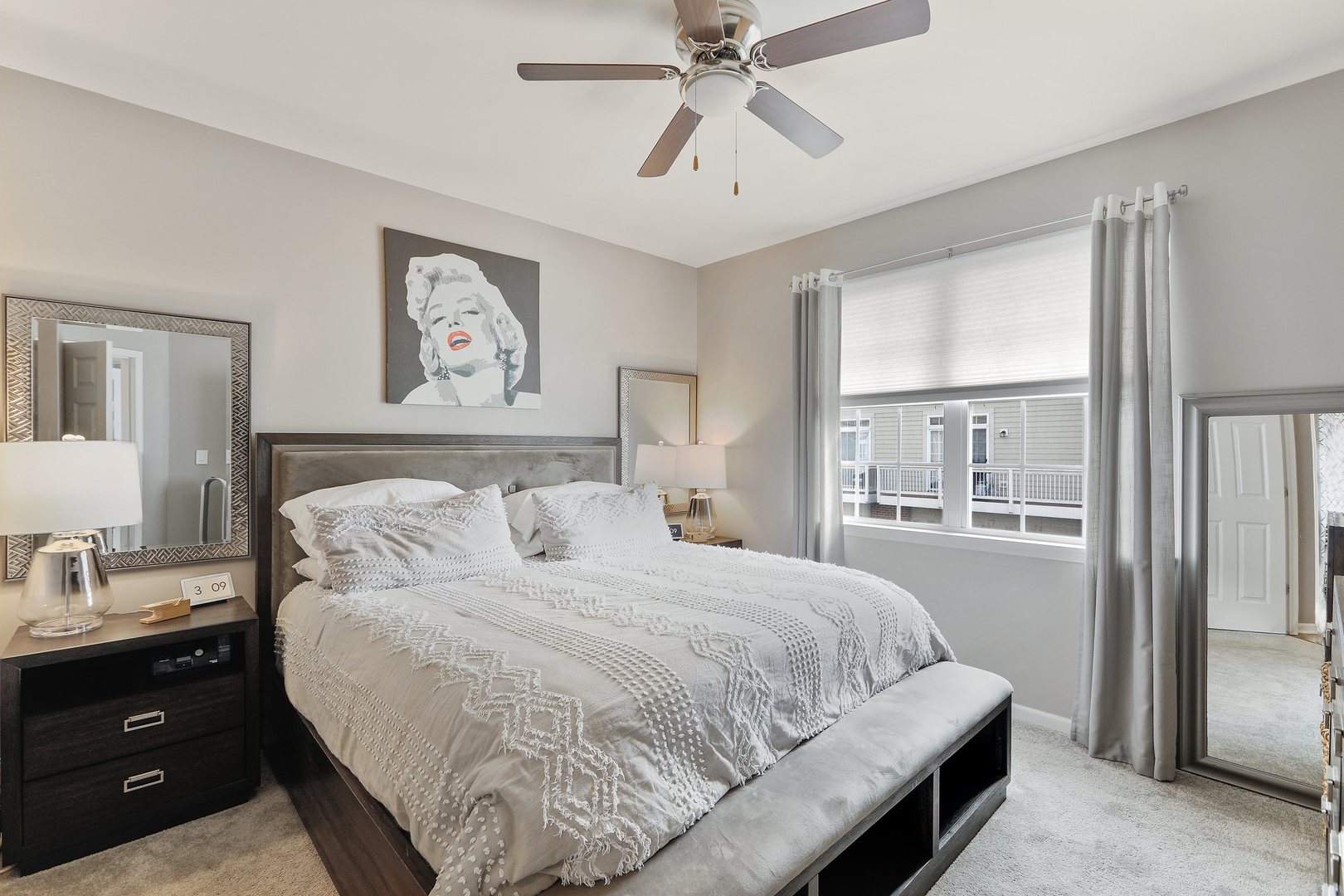301 Timber Ridge Court Joliet, IL 60431 - Photo 8 of 17 a bedroom with a large bed and a chandelier