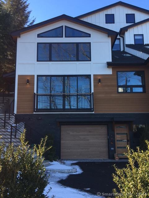 58 Spring Street Greenwich, CT 06830 - Photo 1 of 1 a front view of a house with a yard