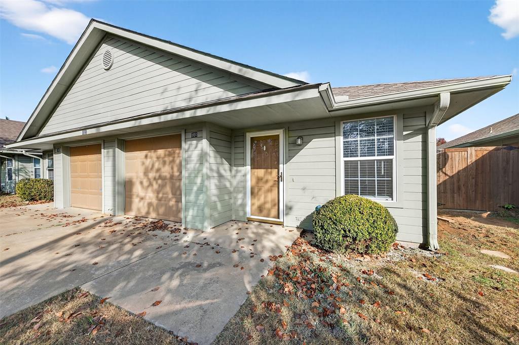 1021 Rice Street, Unit 101 Denison, TX 75020 - Photo 3 of 22 a front view of a house with garden