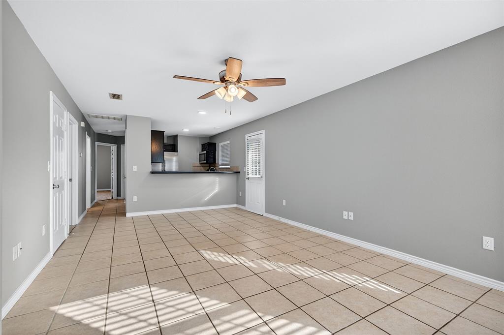 1021 Rice Street, Unit 101 Denison, TX 75020 - Photo 6 of 22 a view of a hallway with a chandelier fan and windows