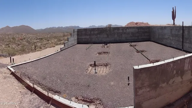 a view of terrace with mountain and trees in the background